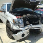 Before and after photographs of a damaged Ford pickup truck that was repaired by Elite Paint & Body Shop in West Palm Beach, Florida.